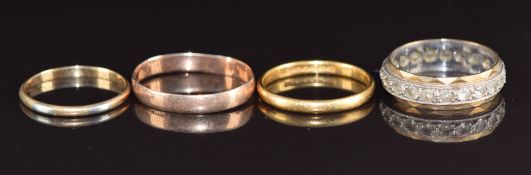 A 9ct gold eternity ring (2.7g, size M), a bi-coloured ring marked 14k-18k (0.9g, size K) a 9ct rose