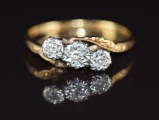 An 18ct gold ring set with three diamonds in a platinum setting, 2.3g, size M