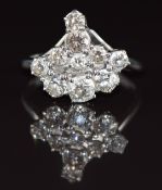 An 18ct white gold ring set with a cluster of old cut diamonds, the largest approximately 0.28ct,