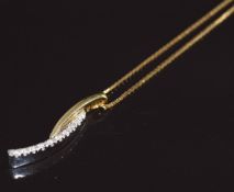 An 18ct bi-coloured gold pendant set with diamonds by Raima (2.2cm) on 18ct gold chain, 5g, 44cm