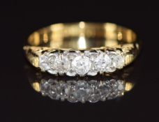An 18ct gold ring set with five graduated diamonds, 2.7g, size K