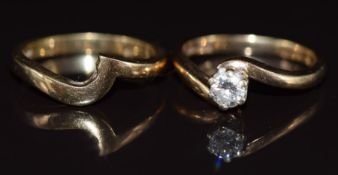 An 18ct gold ring set with a round brilliant cut diamond of approximately 0.2ct, with an 18ct gold