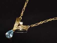 A 9ct gold necklace set with a pear cut topaz and a diamond, 3.6g, 44cm long
