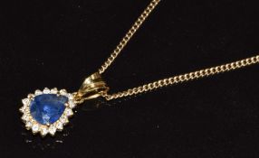 An 18k gold pendant set with a pear cut sapphire of approximately 1.7ct surrounded by diamonds, on