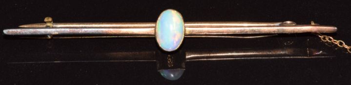 A 9ct gold bar brooch set with an opal cabochon, 2.6g, 6cm