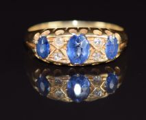 An 18ct gold ring set with oval cut sapphires and diamonds, Birmingham 1919, 2.8g, size M