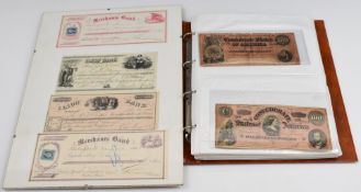 American Civil War interest banknotes in album and framed display of four cheques including