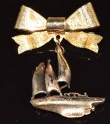 A 9ct gold bow brooch (2.8cm) with 9ct gold charm in the form of Gipsy Moth IV (2.5 x 2.7cm), 6.7g