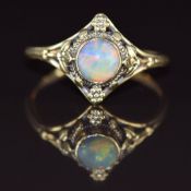 Arts & Crafts 18ct gold ring set with an opal cabochon in a foliate setting, 2.6g, size O/P