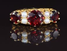 A 9ct gold ring set with garnets and pearls, 3.1g, size L