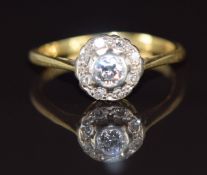 An 18ct gold ring set with diamonds in a cluster, the centre diamond approximately 0.15ct,  2.3g,