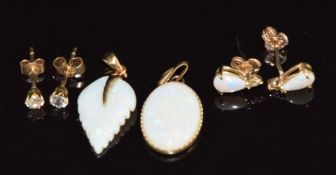 Two 9ct gold pendants set with opal, a pair of 9ct gold earrings set with opals and another pair