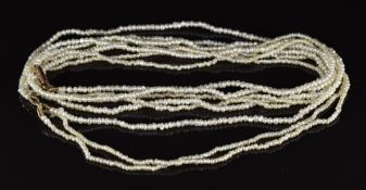 A c1910 four strand seed pearl necklace with 9ct rose gold barrel clasp, 8.2g, 45cm long