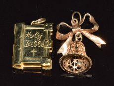 Two 9ct gold pendants / charms in the form of a Bible and a bell, 7.5g