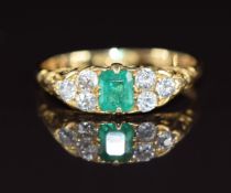 Victorian 18ct gold ring set with an apple green emerald cut emerald of approximately 0.35ct and six