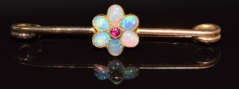 A 9ct gold brooch set with a ruby and opals in a flower setting, 2g, 3.7cm