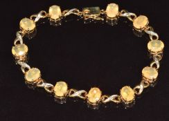 A 9ct gold bracelet set with fire opals and white sapphires, the opals approximately 9.5ct, 9.1g,