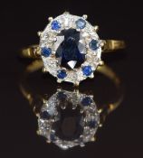 An 18ct gold ring set with an oval cut sapphire of approximately 1.8ct surrounded by diamonds and