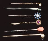 A collection of stick pins comprising 9ct gold set with an opal cabochon (0.7g), two pearl set, a