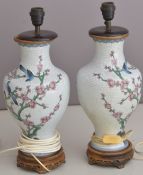 Pair of Chinese cloisonné lamps with prunus and bird decoration, height 54cm