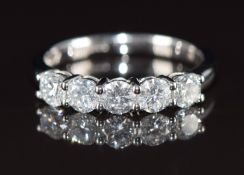 An 18ct white gold ring set with five round brilliant cut diamonds, the total diamond weight
