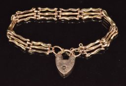 A 9ct rose gold gate bracelet with heart padlock clasp, 17cm long, 10g