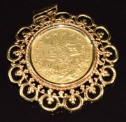 A 9ct gold pendant set with a gold coin, 10.2g, 3.6cm