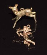 A 9ct gold charm/ pendant in the form of a fawn with synthetic ruby eyes and a 9ct gold charm in the