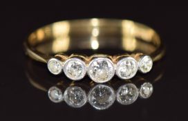 A c1930 18ct gold ring set with five diamonds, the centre diamond approximately 0.14ct, 2.1g, size J