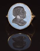 A 9ct gold ring set with a hardstone intaglio portrait, 6.2g, size Y