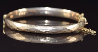 A 9ct gold bangle with faceted decoration, Birmingham 1971, 9.8g, 6 x 5.2cm