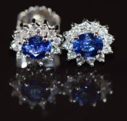 A pair of 18k white gold earrings each set with an oval cut sapphire of approximately 0.5ct