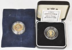 A cased 1997 silver proof 20p Britannia coin, together with a silver proof Guernsey £1 coin, both