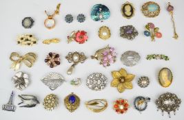 A collection of vintage brooches including abalone, horseshoe and shamrock, Wedgwood etc