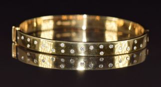 An 18ct gold bangle set with diamonds, 31.7g, 5.8 x 5cm