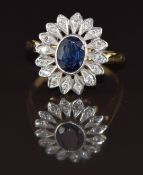 An 18ct gold ring set with an oval cut sapphire of approximately 0.9ct surrounded by diamonds in a