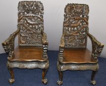 Pair of Chinese carved hardwood chairs with serpentine fronts, pierced dragon decoration and