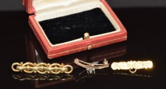 A 15ct gold brooch (3.6g), 9k gold brooch with engraved decoration and loop and a 9ct gold brooch