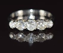 An 18ct white gold ring set with five old cut diamonds in a platinum setting the total diamond