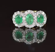 An 18ct gold ring set with three oval cut emeralds of approximately 0.5, 0.35 and 0.35ct