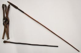 African tribal carved travelling table with elephant decoration, knobkerrie and spear, length 148cm