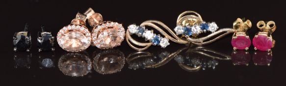 A pair of 14k gold earrings each set with an oval cut ruby (0.9g), 9k white gold earrings each set