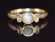 A 9ct gold ring set with a cat's eye green sapphire cabochon and four diamonds, 2g, size F