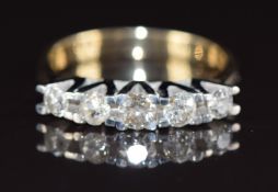 An 18ct gold ring set with five diamonds, the centre diamond approximately 0.21ct, 5.0g, size P