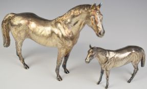 Pair of Elizabeth II novelty silver models of horses, the smaller hallmarked on tail for London,