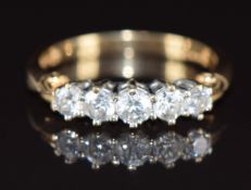 A 14k gold ring set with five cubic zirconia, 3.4g, size P