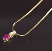 An 18k gold pendant set with an oval cut ruby of approximately 0.9ct and diamonds totalling