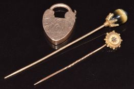 A 14k gold stick pin set with tiger's eye (2.2g, 7cm), 9ct gold stick pin set with a diamond (0.