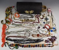 A collection of jewellery including garnet, amber, diamanté and Monet necklaces, vintage brooches