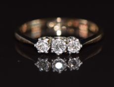 An 18ct gold ring set with three diamonds in a platinum setting, 1.6g, size K